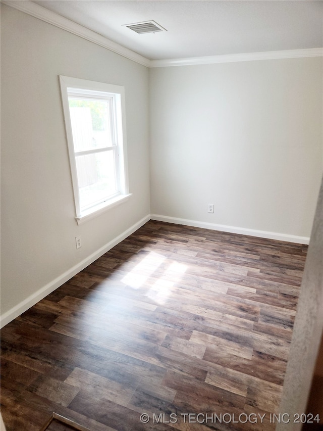 unfurnished room featuring ornamental molding and dark hardwood / wood-style flooring