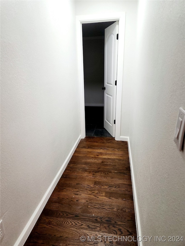 hall with dark hardwood / wood-style flooring