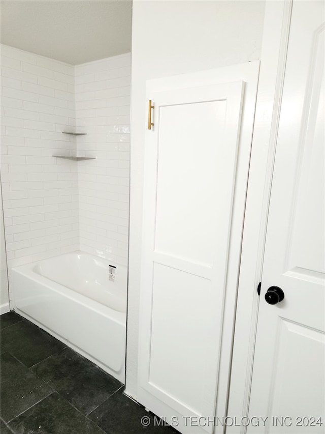 bathroom featuring tiled shower / bath combo and tile patterned floors