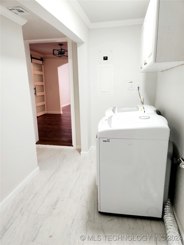 clothes washing area with light hardwood / wood-style floors, crown molding, cabinets, electric panel, and washer and dryer