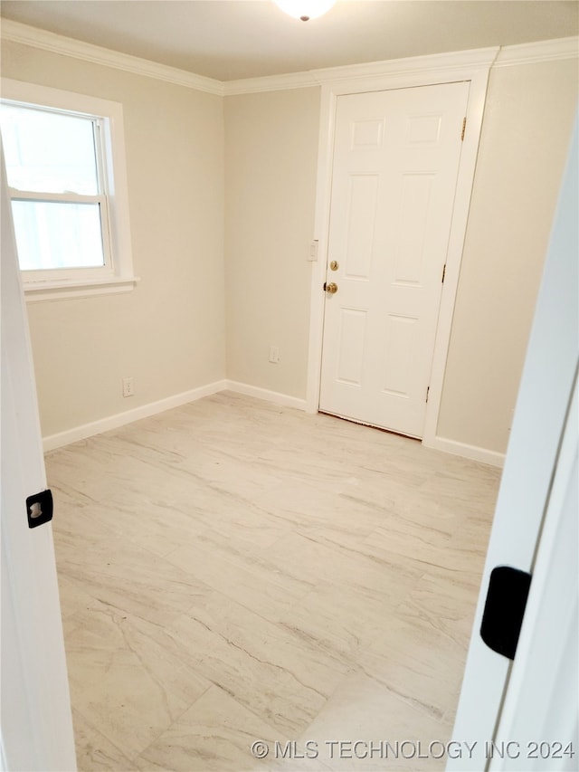 unfurnished room featuring crown molding