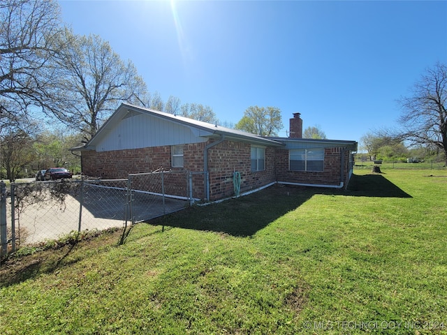 back of property featuring a lawn