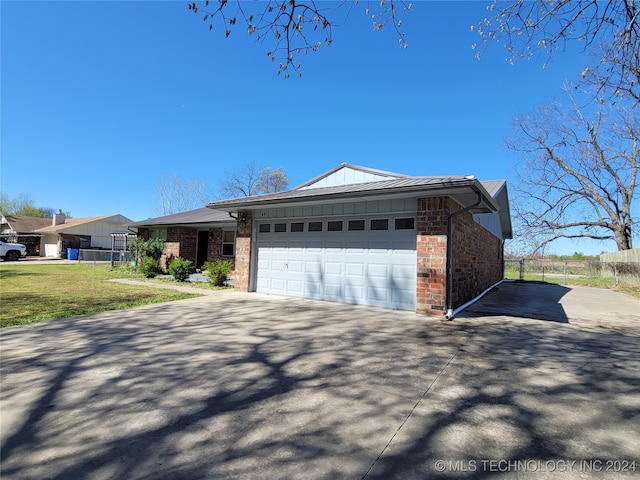 view of front of property with a garage and a front lawn