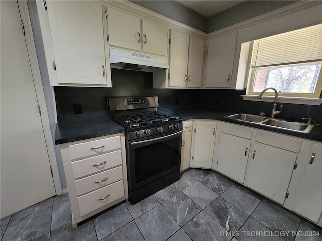 kitchen with white cabinetry, stainless steel range with gas stovetop, tasteful backsplash, and sink