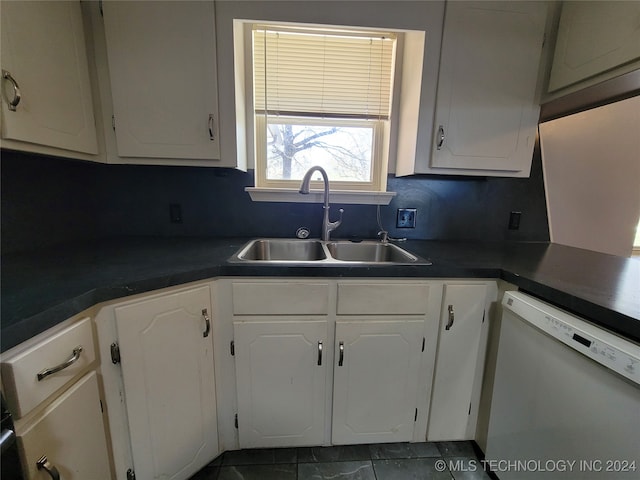 kitchen featuring white dishwasher, backsplash, sink, and white cabinetry