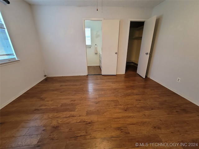 unfurnished bedroom with dark hardwood / wood-style floors