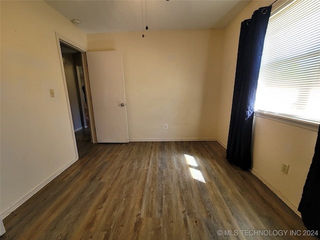 unfurnished room featuring dark hardwood / wood-style floors