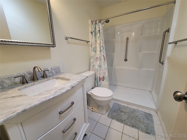 bathroom featuring vanity, toilet, tile patterned floors, and a shower with curtain