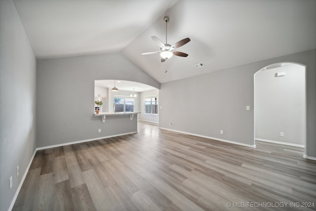 unfurnished living room with hardwood / wood-style flooring, ceiling fan, and lofted ceiling