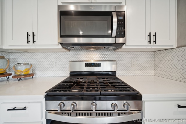 kitchen featuring backsplash, white cabinets, and stainless steel appliances