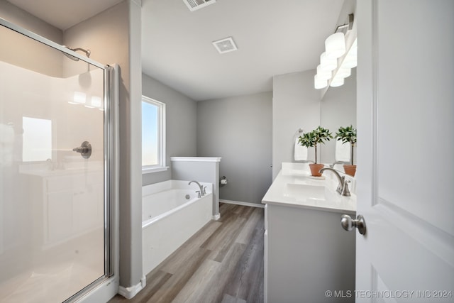 bathroom with separate shower and tub, hardwood / wood-style floors, and vanity