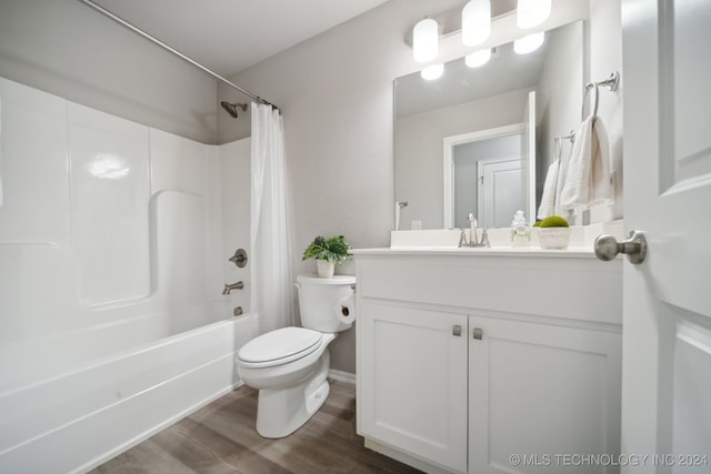 full bathroom featuring toilet, vanity, hardwood / wood-style flooring, and shower / tub combo with curtain