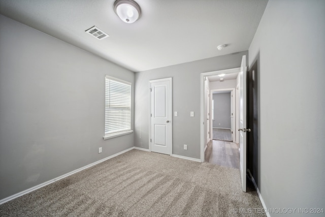 unfurnished bedroom with carpet and a closet