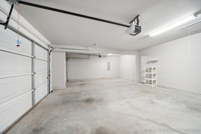 garage with electric panel and a garage door opener