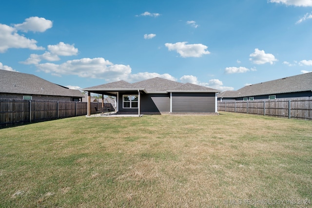 back of house featuring a yard and a patio