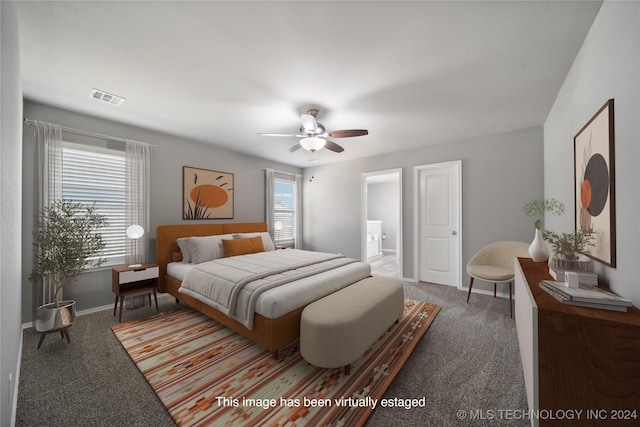 bedroom featuring carpet floors, ensuite bathroom, and ceiling fan