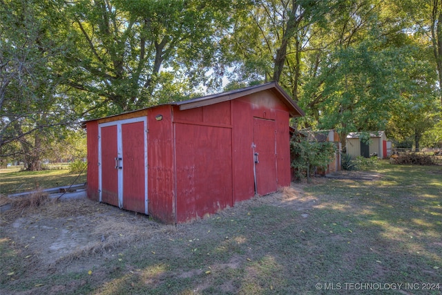 view of outdoor structure featuring a lawn