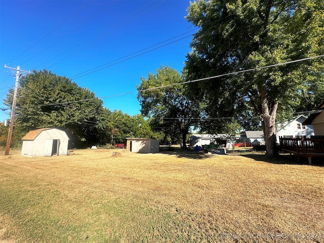 view of yard featuring a deck and a shed