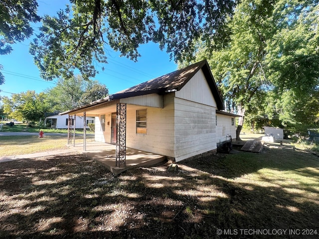 view of side of home with a lawn