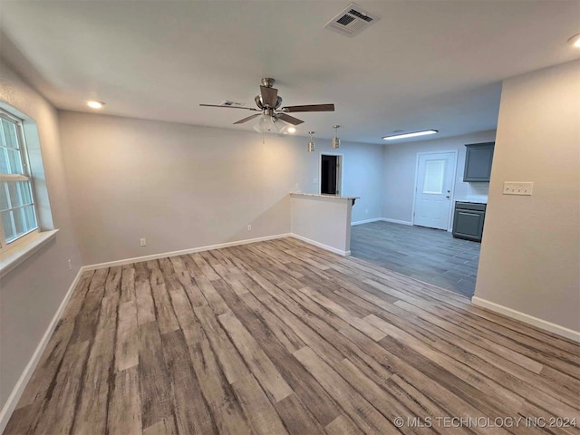 spare room featuring ceiling fan and hardwood / wood-style floors