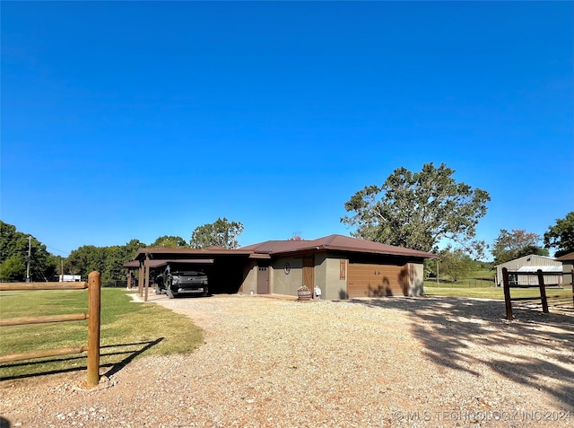 view of front of home with a front yard and a carport