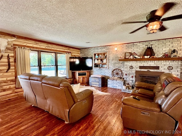 living room with wood-type flooring and a textured ceiling