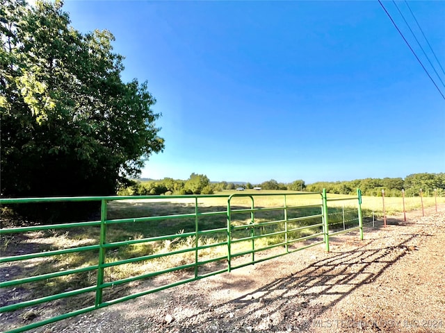 view of yard featuring a rural view and an outbuilding