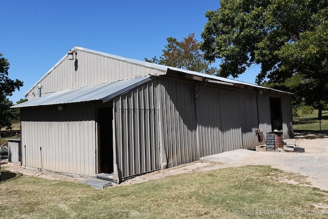 view of home's exterior featuring a lawn and an outdoor structure