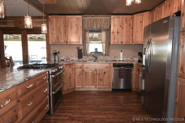 kitchen featuring sink, decorative light fixtures, dark wood-type flooring, stainless steel appliances, and light stone countertops