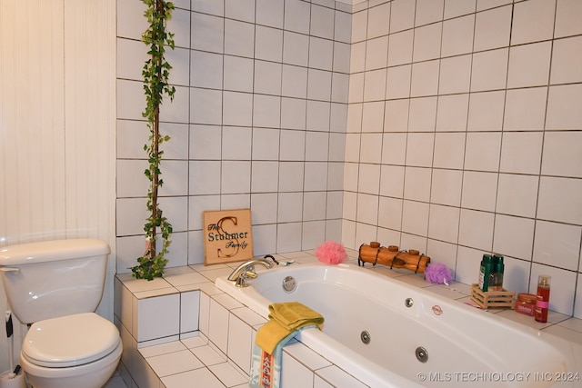 bathroom with tiled bath, tile walls, and toilet