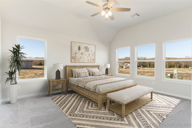 carpeted bedroom with ceiling fan, lofted ceiling, and multiple windows