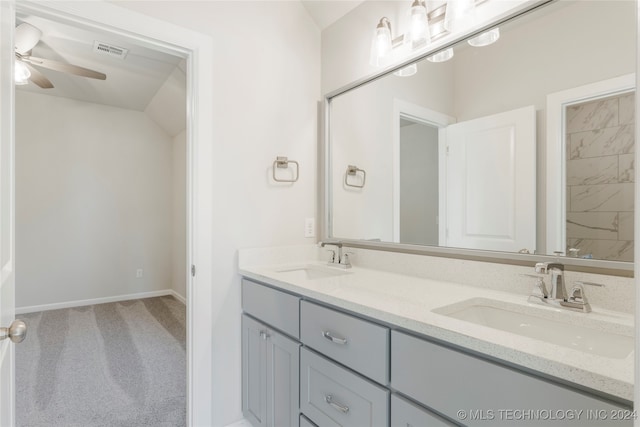 bathroom featuring vanity, ceiling fan, and vaulted ceiling