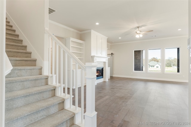 interior space featuring hardwood / wood-style flooring, ceiling fan, and crown molding