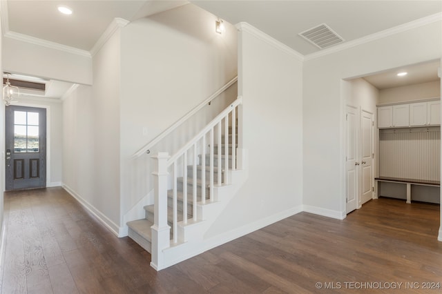 entrance foyer with dark wood-type flooring and ornamental molding