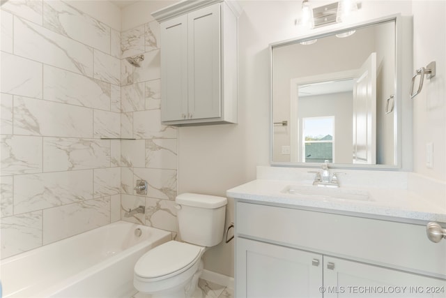 full bathroom with vanity, tiled shower / bath combo, and toilet