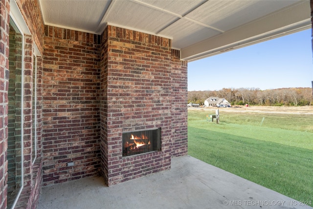 view of patio with an outdoor brick fireplace