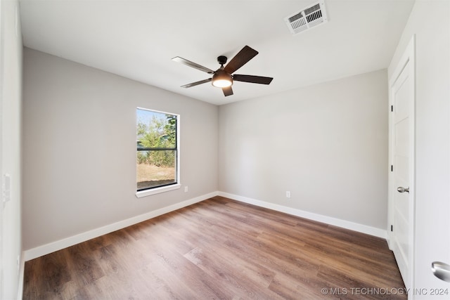 spare room with ceiling fan and hardwood / wood-style flooring