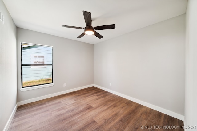 unfurnished room with ceiling fan and hardwood / wood-style flooring