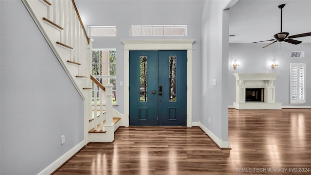 foyer entrance featuring wood-type flooring and ceiling fan