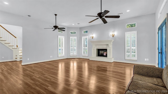 unfurnished living room with ceiling fan and hardwood / wood-style floors