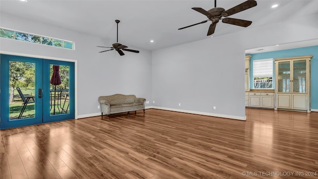 interior space with a healthy amount of sunlight, ceiling fan, french doors, and hardwood / wood-style flooring