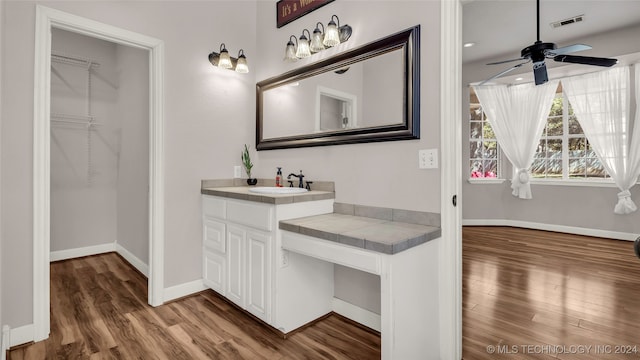 bathroom with wood-type flooring, ceiling fan, and vanity