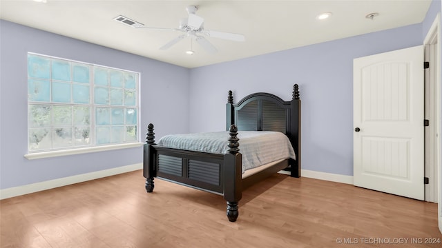 bedroom with ceiling fan and light hardwood / wood-style floors