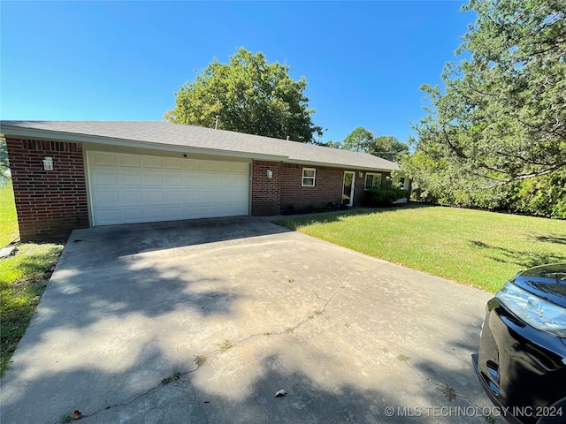 ranch-style house with a garage and a front lawn