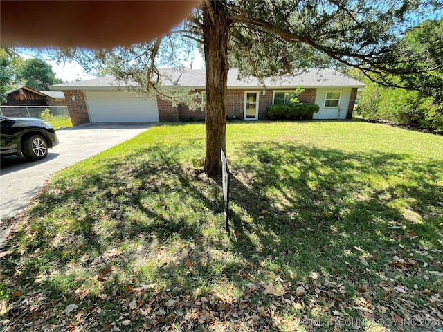 ranch-style house with a garage and a front lawn