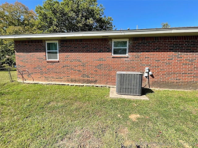 view of property exterior featuring cooling unit and a yard