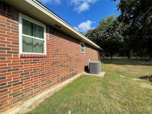 view of property exterior featuring a yard and central air condition unit