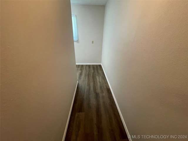 hallway with hardwood / wood-style floors