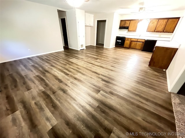 unfurnished living room with dark hardwood / wood-style floors and ceiling fan