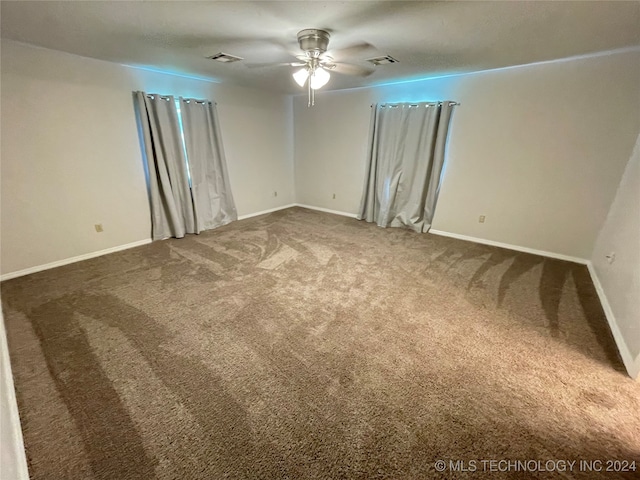 unfurnished room with ceiling fan and carpet flooring